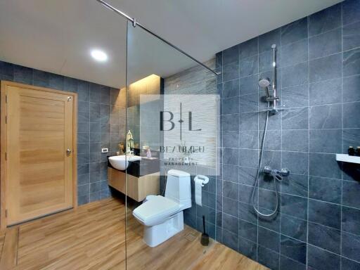 Modern bathroom with walk-in shower and wooden flooring