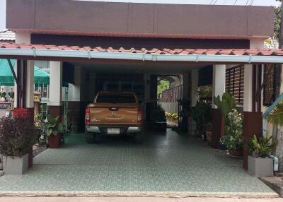 Covered carport with parked vehicle