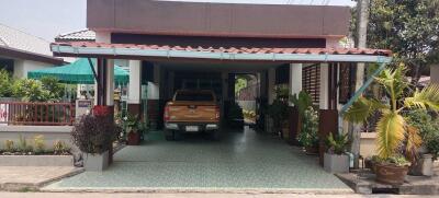 Covered carport with parked vehicle