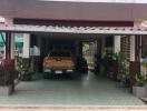 Covered carport with parked vehicle