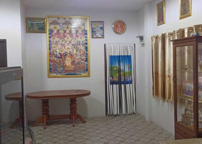 Living room with decorative wall art and glass cabinet