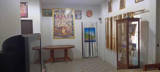 Living room with decorative wall art and glass cabinet