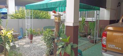 Covered patio with garden and parked vehicle