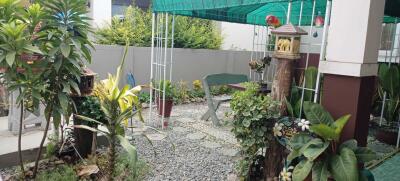 Outdoor patio with garden and seating area