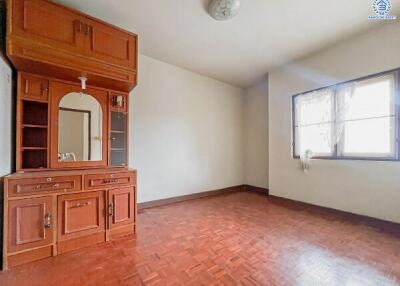 Empty bedroom with wooden cabinet and window