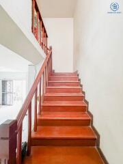 Staircase with wooden steps and railing