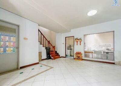 Spacious living area with stairs to the upper floor and a view into the kitchen