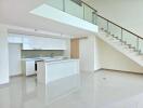 Modern kitchen with a central island and staircase view