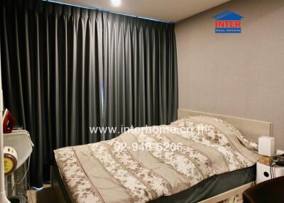 Bedroom with bed and dark curtains