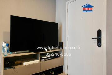 Living room with TV and entrance door