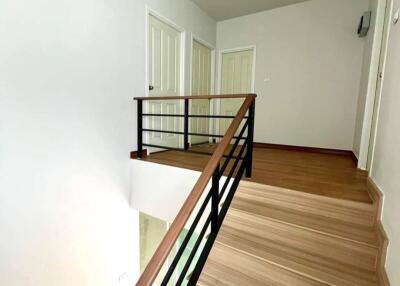 Staircase and hallway with white doors