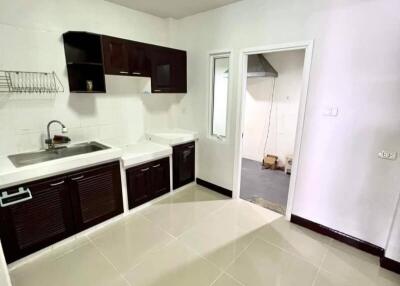 Modern kitchen with dark cabinets and white countertops