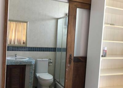 Bathroom with a sink, toilet, and glass shower enclosure