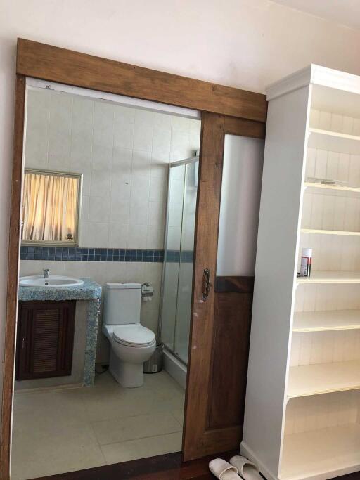 Bathroom with a sink, toilet, and glass shower enclosure