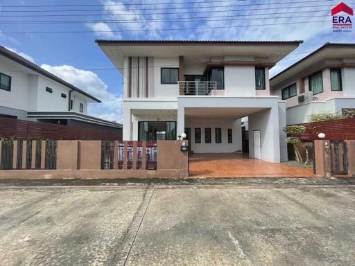 Modern two-story house with a gated compound