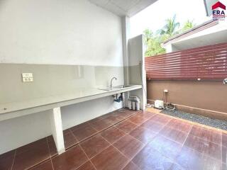 Outdoor kitchen area with sink and countertop