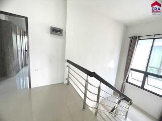 Second floor staircase landing with window view