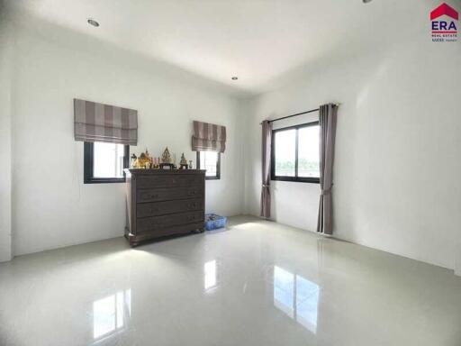 Simple bedroom with dresser and windows