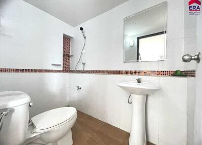 Modern bathroom with white fixtures and a walk-in shower.