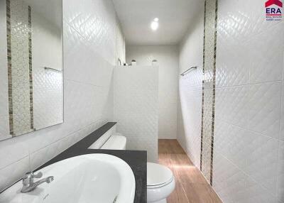 Modern bathroom with walk-in shower and white tile walls