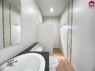 Modern bathroom with walk-in shower and white tile walls