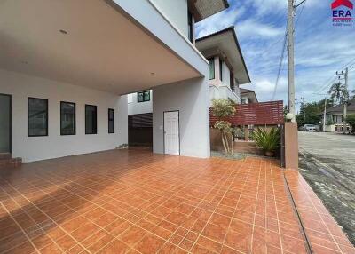 Outdoor view of building with covered walkway and tiled ground