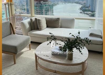 Modern living room with a large window view of the city and river