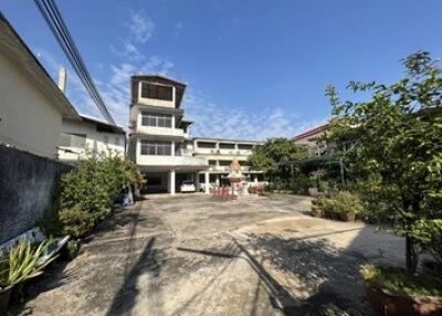 Spacious courtyard with a multi-story building in the background