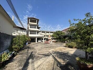 Spacious courtyard with a multi-story building in the background