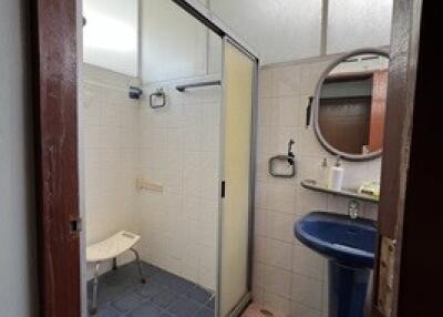 Bathroom with blue sink and glass shower enclosure