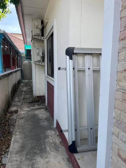 Outdoor side area with air conditioners and a folding ladder