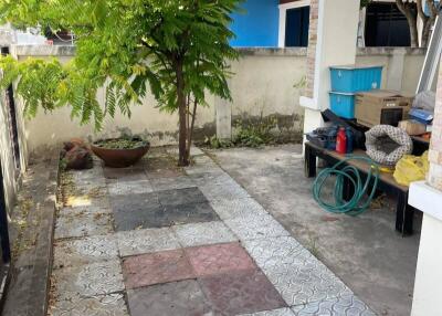 Outdoor patio area with tree and tiled floor