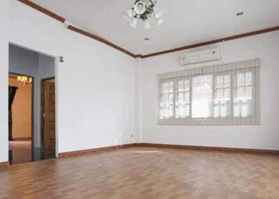 Spacious living room with hardwood floors and large window