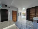 Spacious and modern living area with marble flooring and ample built-in storage