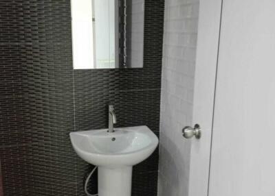 Bathroom with pedestal sink and wall mirror