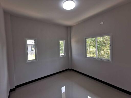 Unfurnished room with windows and natural light