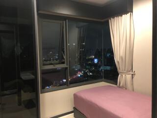 Bedroom with city view at night