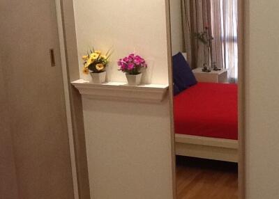 Bedroom with wall mirror and flower pots
