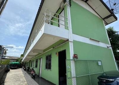 Exterior view of a green apartment building