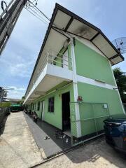 Exterior view of a green apartment building