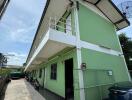 Exterior view of a green apartment building