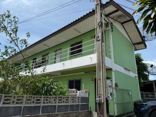 Two-story green residential building exterior