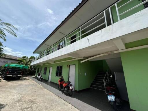 Two-story building with exterior corridors and parking space