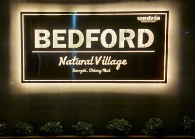 Illuminated sign of Bedford Natural Village, Saraphi, Chiang Mai