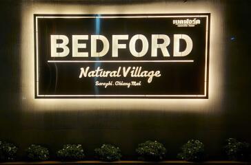 Illuminated sign of Bedford Natural Village, Saraphi, Chiang Mai