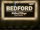 Illuminated sign of Bedford Natural Village, Saraphi, Chiang Mai