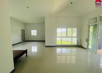 Spacious living room with large windows offering natural light