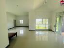 Spacious living room with large windows offering natural light