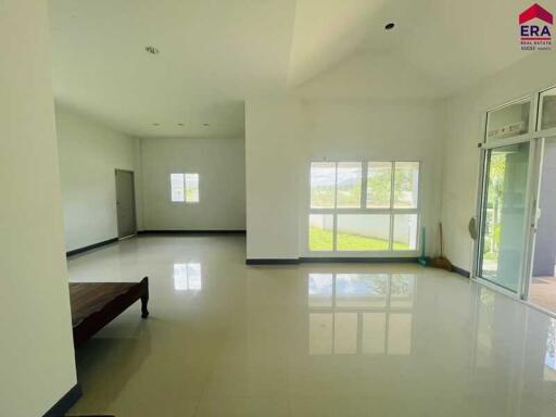 Spacious living room with large windows offering natural light