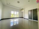 Spacious empty room with large windows and sliding doors
